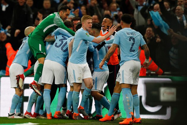 Manchester City's Belgian defender Vincent Kompany celebrates with teammates after scoring their second goal during the English League Cup final football match between Manchester City and Arsenal at Wembley stadium in north London on February 25, 2018. / AFP PHOTO / Adrian DENNIS / RESTRICTED TO EDITORIAL USE. No use with unauthorized audio, video, data, fixture lists, club/league logos or 'live' services. Online in-match use limited to 75 images, no video emulation. No use in betting, games or single club/league/player publications.  /         (Photo credit should read ADRIAN DENNIS/AFP/Getty Images)