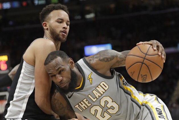 Cleveland Cavaliers' LeBron James (23) drives past San Antonio Spurs' Kyle Anderson in the second half of an NBA basketball game, Sunday, Feb. 25, 2018, in Cleveland. (AP Photo/Tony Dejak)