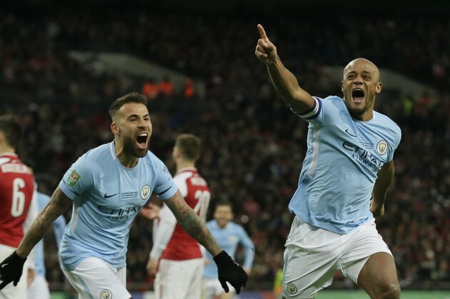 Manchester City's Vincent Kompany, right, celebrates after he scores his sides 2nd goal of the game during the English League Cup Final between Arsenal and Manchester City at Wembley stadium in London, Sunday, Feb. 25, 2018.(AP Photo/Tim Ireland)