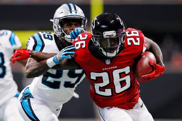 ATLANTA, GA - DECEMBER 31: Tevin Coleman #26 of the Atlanta Falcons is tackled by Mike Adams #29 of the Carolina Panthers on a run during the first half Mercedes-Benz Stadium on December 31, 2017 in Atlanta, Georgia. (Photo by Kevin C.  Cox/Getty Images)