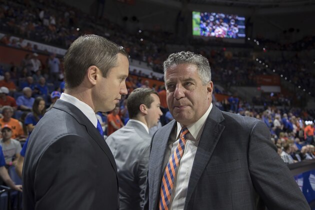 Florida coach Mike White, left, greets Auburn coach Bruce Pearl before an NCAA college basketball game in Gainesville, Fla., Saturday, Feb. 24, 2018. (AP Photo/Ron Irby)