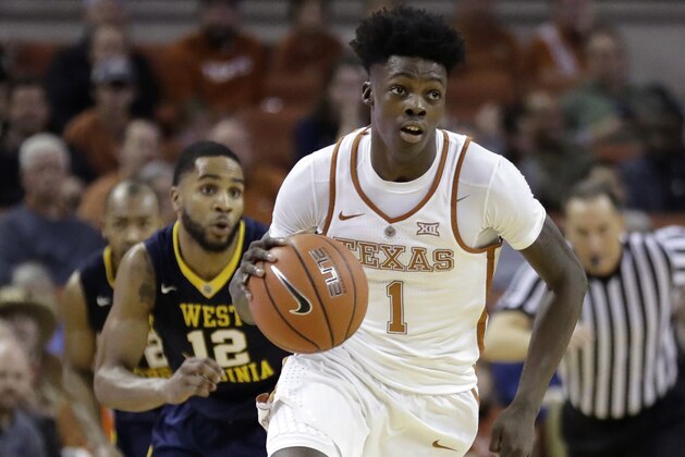 FILE - In this Jan. 14, 2017, file photo, Texas guard Andrew Jones (1) brings the ball up court during the second half of an NCAA college basketball game against West Virginia in Austin, Texas. The announcement that Jones was diagnosed with leukemia prompted concern and well wishes from across college basketball. He is now starting to offer glimpses of how he’s coping with his treatment, and sending “thank you” messages for the emotional and financial support that have poured in to help. (AP Photo/Eric Gay, File)