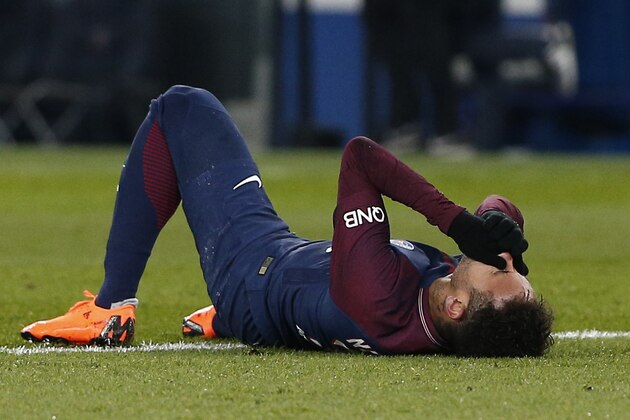 PSG's Neymar lays on the pitch after being fouled during the French League One soccer match between Paris Saint-Germain and Marseille at the Parc des Princes Stadium, in Paris, France, Sunday, Feb. 25, 2018. (AP Photo/Thibault Camus)