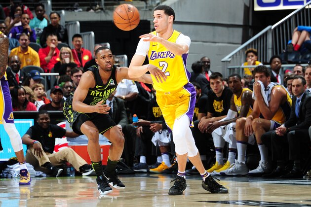 ATLANTA, GA - FEBRUARY 26:  Lonzo Ball #2 of the Los Angeles Lakers passes the ball against Isaiah Taylor #22 of the Atlanta Hawks on February 26, 2018 at Philips Arena in Atlanta, Georgia.  NOTE TO USER: User expressly acknowledges and agrees that, by downloading and/or using this Photograph, user is consenting to the terms and conditions of the Getty Images License Agreement. Mandatory Copyright Notice: Copyright 2018 NBAE (Photo by Scott Cunningham/NBAE via Getty Images)