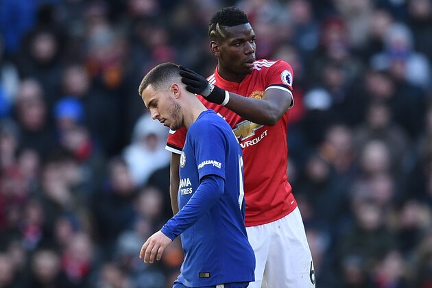 Manchester United's French midfielder Paul Pogba (R) gestures to Chelsea's Belgian midfielder Eden Hazard as Hazard is substituted during the English Premier League football match between Manchester United and Chelsea at Old Trafford in Manchester, north west England, on February 25, 2018. / AFP PHOTO / Oli SCARFF / RESTRICTED TO EDITORIAL USE. No use with unauthorized audio, video, data, fixture lists, club/league logos or 'live' services. Online in-match use limited to 75 images, no video emulation. No use in betting, games or single club/league/player publications.  /         (Photo credit should read OLI SCARFF/AFP/Getty Images)