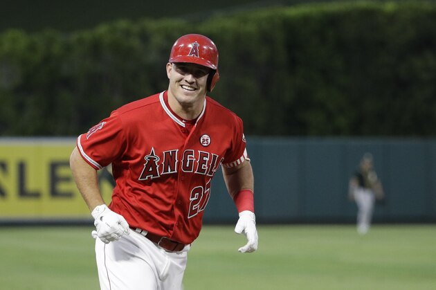 Los Angeles Angels' Mike Trout smiles as he rounds the bases after hitting a home run during the first inning of a baseball game Oakland Athletics, Wednesday, Aug. 30, 2017, in Anaheim, Calif. (AP Photo/Jae C. Hong)