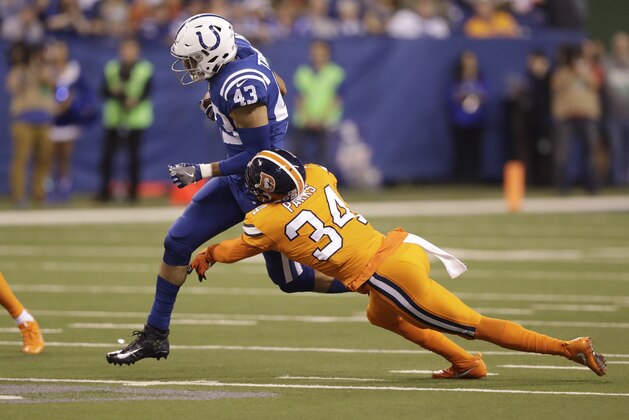 Indianapolis Colts tight end Ross Travis (43) catches a pass as Denver Broncos defensive back Will Parks (34) defends during the first half of an NFL football game in Indianapolis, Thursday, Dec. 14, 2017. (AP Photo/Darron Cummings)