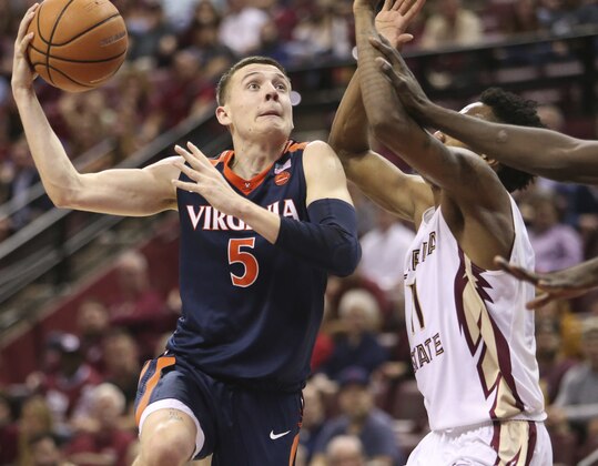 Virginia's Kyle Guy throws up a hook shot over Florida State's Braian Angola in the second half of an NCAA college basketball game, Wednesday, Feb. 7, 2018, in Tallahassee, Fla. Virginia won 59-55. (AP Photo/Steve Cannon)