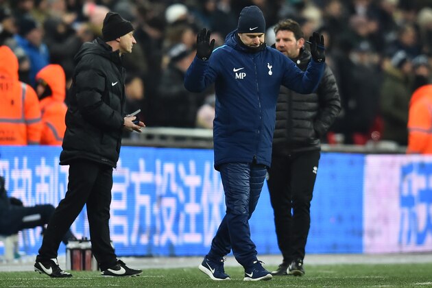 Tottenham Hotspur's Argentinian head coach Mauricio Pochettino (C) walks away after complaining to the fourth official about Tottenham Hotspur's South Korean striker Son Heung-Min yellow card during the English FA Cup 5th round replay football match between Tottenham Hotspur and Rochdale at Wembley Stadium in London, on February 28, 2018. / AFP PHOTO / Glyn KIRK / RESTRICTED TO EDITORIAL USE. No use with unauthorized audio, video, data, fixture lists, club/league logos or 'live' services. Online in-match use limited to 75 images, no video emulation. No use in betting, games or single club/league/player publications.  /         (Photo credit should read GLYN KIRK/AFP/Getty Images)
