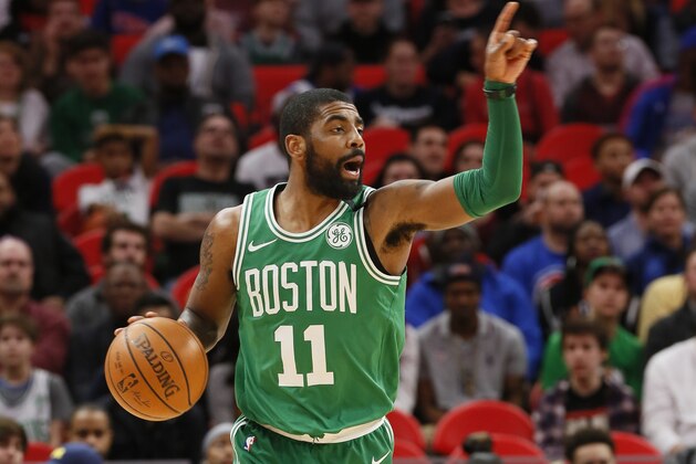 Boston Celtics guard Kyrie Irving (11) directs the offense against the Detroit Pistons during the first half of an NBA basketball game Friday, Feb. 23, 2018, in Detroit. (AP Photo/Duane Burleson)
