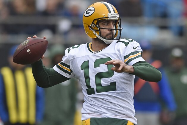 Green Bay Packers' Aaron Rodgers (12) looks to pass against the Carolina Panthers during the first half of an NFL football game in Charlotte, N.C., Sunday, Dec. 17, 2017. (AP Photo/Mike McCarn)