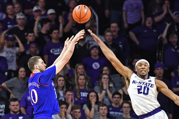 MANHATTAN, KS - JANUARY 29:  Sviatoslav Mykhailiuk #10 of the Kansas Jayhawks shoots and hits a three-point shot against Xavier Sneed #20 of the Kansas State Wildcats during the second half on January 29, 2018 at Bramlage Coliseum in Manhattan, Kansas.  (Photo by Peter G. Aiken/Getty Images)