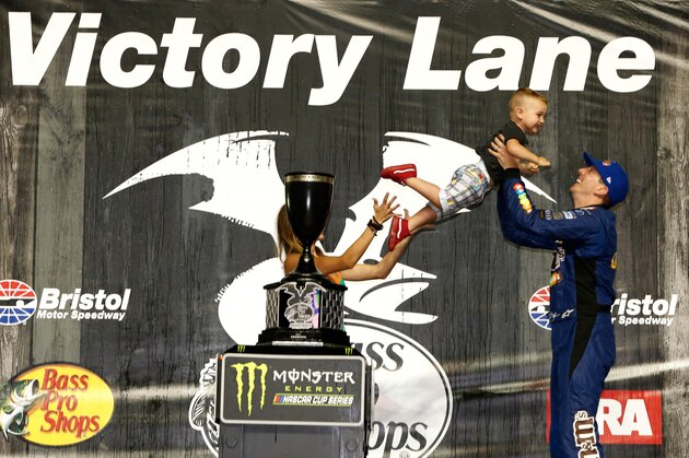 BRISTOL, TN - AUGUST 19:  Kyle Busch, driver of the #18 M&M's Caramel Toyota, celebrates in victory lane with his wife, Samantha, and son, Brexton, after winning the Monster Energy NASCAR Cup Series Bass Pro Shops NRA Night Race at Bristol Motor Speedway on August 19, 2017 in Bristol, Tennessee.  (Photo by Brian Lawdermilk/Getty Images)