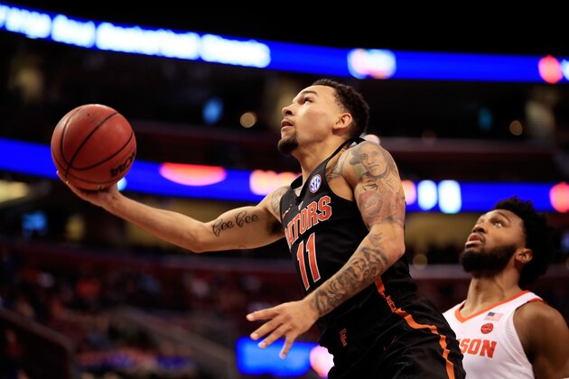SUNRISE, FL - DECEMBER 16:  Chris Chiozza #11 of the Florida Gators shoots against the Clemson Tigers during the MetroPCS Orange Bowl Basketball Classic at BB&T Center on December 16, 2017 in Sunrise, Florida.  (Photo by Cliff Hawkins/Getty Images)