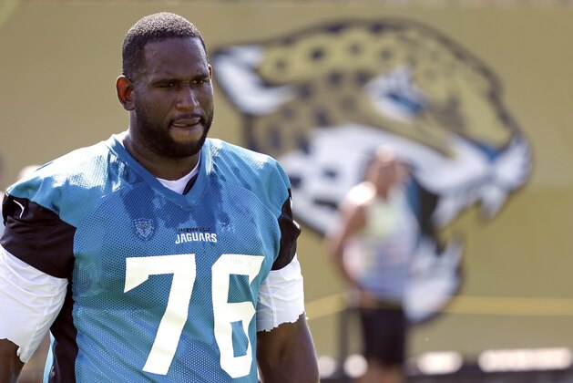 FILE - In this July 28, 2017, file photo, Jacksonville Jaguars offensive lineman Branden Albert (76) arrives at practice during NFL football training camp, in Jacksonville, Fla. A person familiar with the situation says Albert has changed his mind about retiring and asked to return to the team. The person spoke to The Associated Press on the condition of anonymity Monday, Aug. 7, because neither side has publicly discussed details about Albert's potential return. (AP Photo/John Raoux, File)