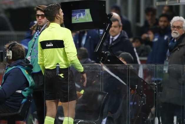 Referee Gianluca Rocchi checks the VAR during the Serie A soccer match between Inter Milan and Lazio, at the Milan's San Siro stadium, Italy, Saturday, Dec. 30, 2017. (AP Photo/Antonio Calanni)