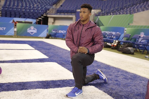 Penn State running back Saquon Barkley warms up at the NFL football scouting combine in Indianapolis, Friday, March 2, 2018. (AP Photo/Michael Conroy)