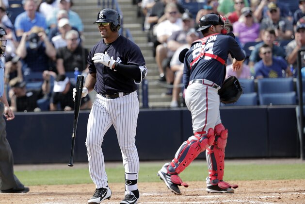 New York Yankees pinch hitter Russell Wilson, a Seattle Seahawks quarterback, left, walks off after striking out in the fifth inning of a baseball spring exhibition game against the Atlanta Braves, Friday, March 2, 2018, in Tampa, Fla. At right is Braves catcher Alex Jackson (84). (AP Photo/Lynne Sladky)