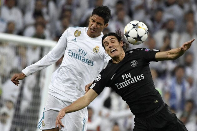 Real Madrid's French defender Raphael Varane (L) vies with Paris Saint-Germain's  Uruguayan forward Edinson Cavani (R) during the UEFA Champions League round of sixteen first leg football match Real Madrid CF against Paris Saint-Germain (PSG) at the Santiago Bernabeu stadium in Madrid on February 14, 2018.   / AFP PHOTO / CHRISTOPHE SIMON        (Photo credit should read CHRISTOPHE SIMON/AFP/Getty Images)