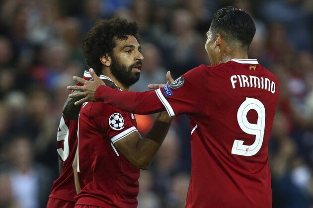 Liverpool's Mohamed Salah, left, celebrates scoring his sides second goal with Liverpool's Roberto Firmino during the Champions League qualifying play-off second leg soccer match between Liverpool and Hoffenheim at Anfield stadium in Liverpool, England, Wednesday, Aug. 23, 2017. (AP Photo/Dave Thompson)