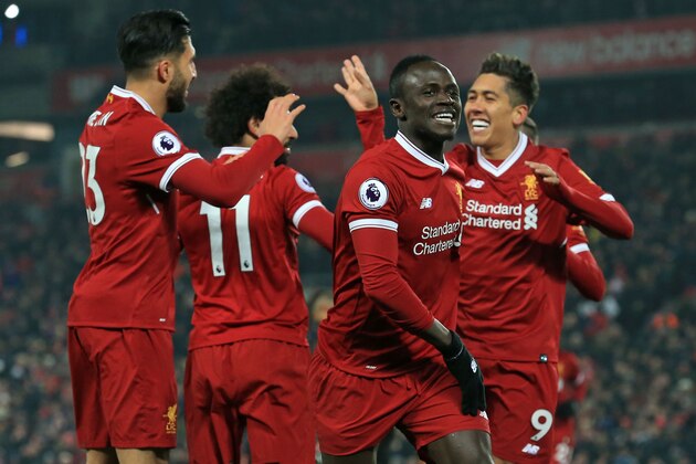 Liverpool's Senegalese midfielder Sadio Mane (2nd R) celebrates with teammates after scoring their second goal during the English Premier League football match between Liverpool and Newcastle at Anfield in Liverpool, north west England on March 3, 2018. / AFP PHOTO / Lindsey PARNABY / RESTRICTED TO EDITORIAL USE. No use with unauthorized audio, video, data, fixture lists, club/league logos or 'live' services. Online in-match use limited to 75 images, no video emulation. No use in betting, games or single club/league/player publications.  /         (Photo credit should read LINDSEY PARNABY/AFP/Getty Images)