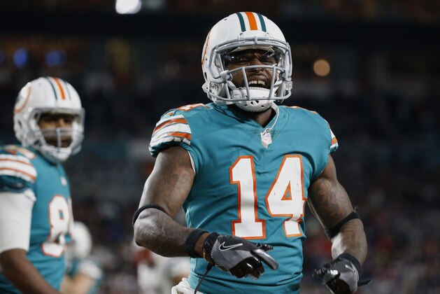 Miami Dolphins wide receiver Jarvis Landry (14) celebrates his touchdown during the second half of an NFL football game against the New England Patriots, Monday, Dec. 11, 2017, in Miami Gardens, Fla. Behind Landry isMiami Dolphins tight end Julius Thomas (89). (AP Photo/Wilfredo Lee)
