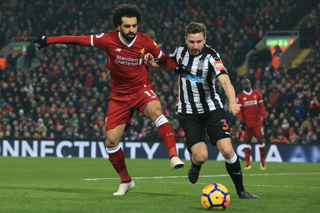 Newcastle United's Welsh defender Paul Dummett concedes a corner as Liverpool's Egyptian midfielder Mohamed Salah (L) attacks during the English Premier League football match between Liverpool and Newcastle at Anfield in Liverpool, north west England on March 3, 2018. / AFP PHOTO / Lindsey PARNABY / RESTRICTED TO EDITORIAL USE. No use with unauthorized audio, video, data, fixture lists, club/league logos or 'live' services. Online in-match use limited to 75 images, no video emulation. No use in betting, games or single club/league/player publications.  /         (Photo credit should read LINDSEY PARNABY/AFP/Getty Images)