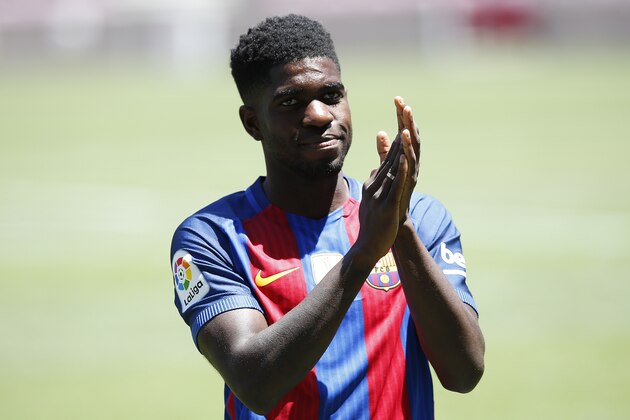 FC Barcelona's new signing Samuel Umtiti applauds during his official presentation at the Camp Nou stadium in Barcelona, Spain, Friday, July 15, 2016. Barcelona has signed France defender Samuel Umtiti to a five-year contract after securing his transfer from Lyon. (AP Photo/Manu Fernandez)