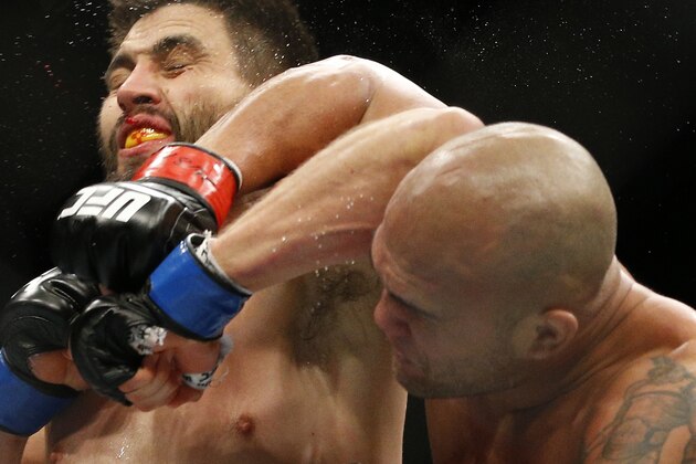 Robbie Lawler, right, lands an elbow to Carlos Condit during a welterweight championship mixed martial arts bout at UFC 195, Saturday, Jan. 2, 2016, in Las Vegas. (AP Photo/John Locher)