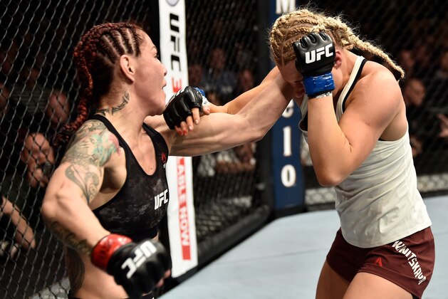 LAS VEGAS, NV - MARCH 03:   (L-R) Cris Cyborg of Brazil punches Yana Kunitskaya of Russia in their women's featherweight bout during the UFC 222 event inside T-Mobile Arena on March 3, 2018 in Las Vegas, Nevada. (Photo by Jeff Bottari/Zuffa LLC/Zuffa LLC via Getty Images)