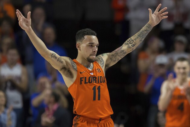 Florida guard Chris Chiozza (11) acknowledges the crowd as he leaves the game in the final minute of an NCAA college basketball game against Kentucky in Gainesville, Fla., Saturday, March 3, 2018. Florida won 80-67. (AP Photo/Ron Irby)