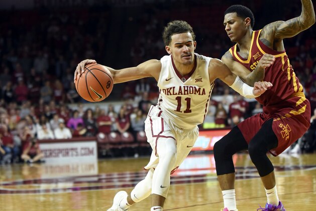 OKlahoma's Trae Young, left, drives past Iowa State's Donovan Jackson, right, in the second half of an NCAA college basketball game Friday, March 2, 2018, in Norman, Okla. (AP Photo/Kyle Phillips)