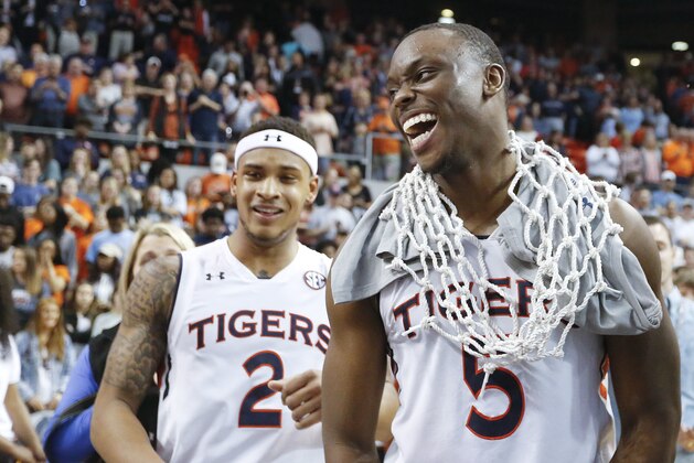 Auburn guard Mustapha Heron, right, wears a basketball net after an NCAA college basketball game against South Carolina, Saturday, March 3, 2018, in Auburn, Ala. (AP Photo/Brynn Anderson)