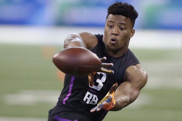 Penn State running back Saquon Barkley runs a drill during the NFL football scouting combine, Friday, March 2, 2018, in Indianapolis. (AP Photo/Darron Cummings)