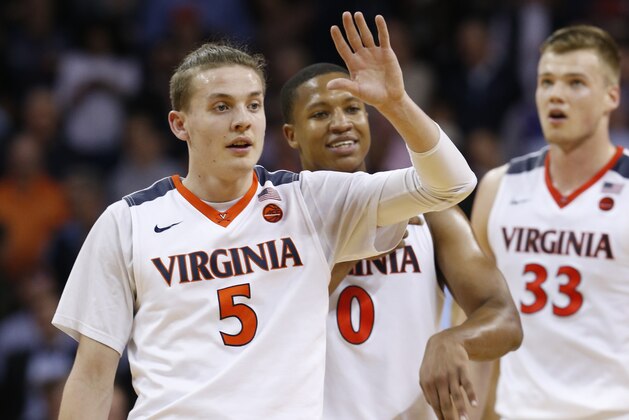Virginia guard Kyle Guy (5) and guard Devon Hall (0) celebrate a shot during the second half of an NCAA college basketball game against North Carolina in Charlottesville, Va., Monday, Feb. 27, 2017. Virginia won 53-43. (AP Photo/Steve Helber)