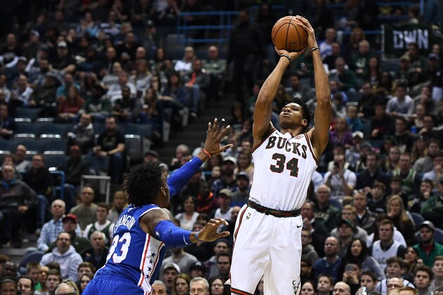MILWAUKEE, WI - MARCH 04:  Giannis Antetokounmpo #34 of the Milwaukee Bucks shoots over Robert Covington #33 of the Philadelphia 76ers during the first half of a game at the Bradley Center on March 4, 2018 in Milwaukee, Wisconsin.  NOTE TO USER: User expressly acknowledges and agrees that, by downloading and or using this photograph, User is consenting to the terms and conditions of the Getty Images License Agreement.  (Photo by Stacy Revere/Getty Images)