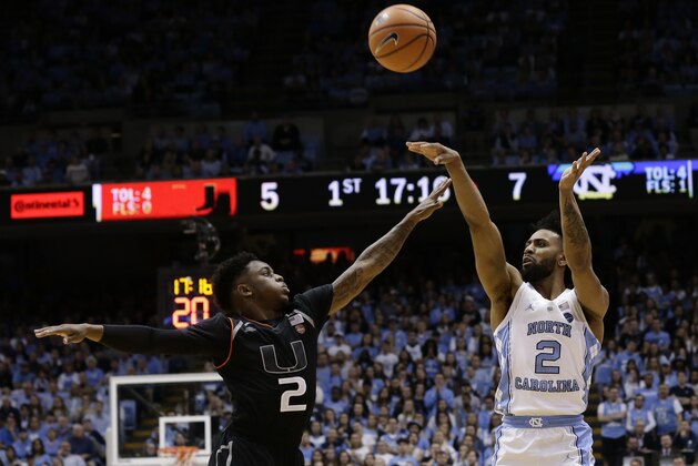 North Carolina's Joel Berry II (2) shoots while Miami's Chris Lykes (2) defends during the first half of an NCAA college basketball game in Chapel Hill, N.C., Tuesday, Feb. 27, 2018. (AP Photo/Gerry Broome)