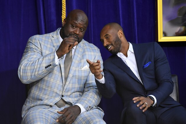 Shaquille O'Neal, left, and Kobe Bryant chat at the unveiling of his statue in front of Staples Center, Friday, March 24, 2017, in Los Angeles. (AP Photo/Mark J. Terrill)