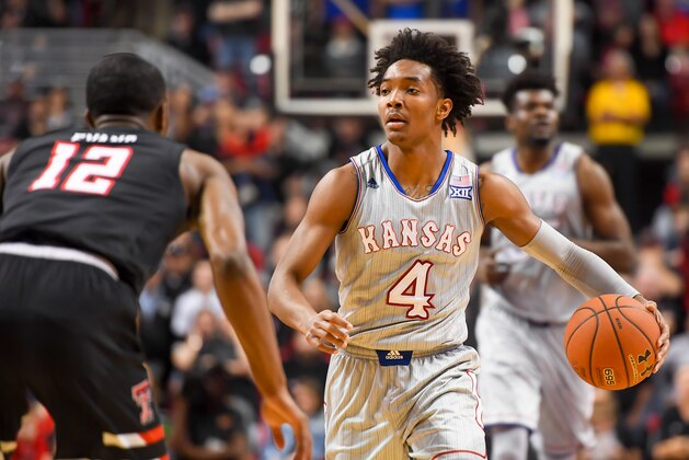 LUBBOCK, TX - FEBRUARY 24: Devonte' Graham #4 of the Kansas Jayhawks handles the ball against Keenan Evans #12 of the Texas Tech Red Raiders during the game on February 24, 2018 at United Supermarket Arena in Lubbock, Texas. Kansas defeated Texas Tech 74-72. (Photo by John Weast/Getty Images)
