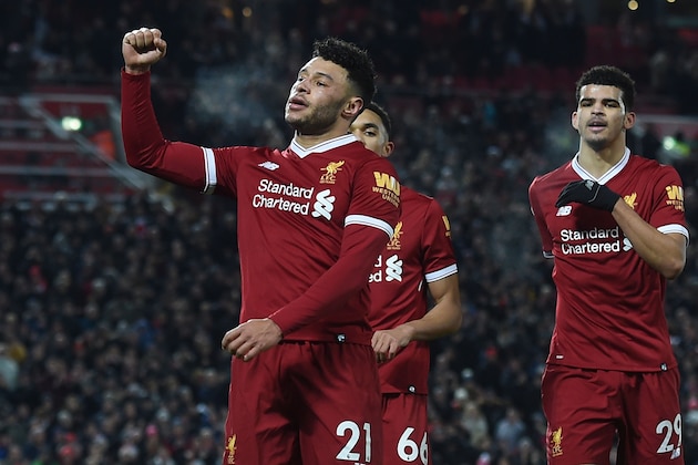 Liverpool's English midfielder Alex Oxlade-Chamberlain (L) celebrates scoring their fifth goal with Liverpool's English midfielder Trent Alexander-Arnold (C) and Liverpool's English striker Dominic Solanke (R) during the English Premier League football match between Liverpool and Swansea City at Anfield in Liverpool, north west England on December 26, 2017. / AFP PHOTO / PAUL ELLIS / RESTRICTED TO EDITORIAL USE. No use with unauthorized audio, video, data, fixture lists, club/league logos or 'live' services. Online in-match use limited to 75 images, no video emulation. No use in betting, games or single club/league/player publications.  /         (Photo credit should read PAUL ELLIS/AFP/Getty Images)