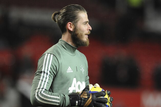 Manchester United's goalkeeper David de Gea takes part in the warm up prior to the English Premier League soccer match between Manchester United and Stoke City at Old Trafford in Manchester, England, Monday, Jan. 15, 2018. (AP Photo/Rui Vieira)