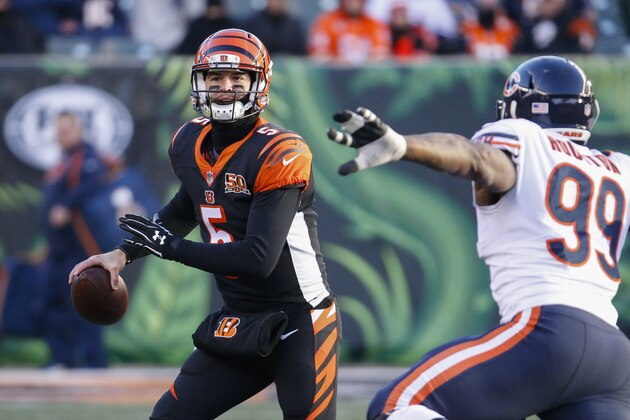Cincinnati Bengals quarterback AJ McCarron (5) looks to pass under pressure from Chicago Bears linebacker Lamarr Houston (99) in the second half of an NFL football game, Sunday, Dec. 10, 2017, in Cincinnati. (AP Photo/Frank Victores)
