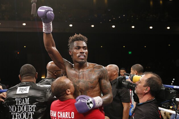 Jermall Charlo celebrates after defeating Austin Trout in a junior middleweight title boxing bout Saturday, May 21, 2016, in Las Vegas. (AP Photo/John Locher)