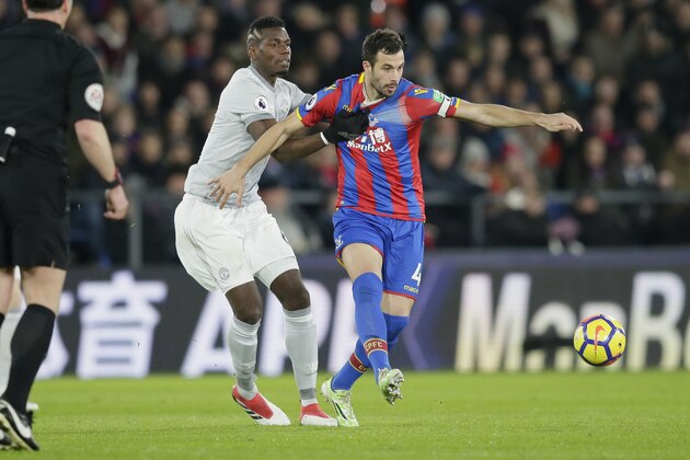 Crystal Palace's Luka Milivojevic, right, competes for the ball with Manchester United's Paul Pogba during the English Premier League soccer match between Crystal Palace and Manchester United at Selhurst Park in London, Monday, March 5, 2018. (AP Photo/Tim Ireland)