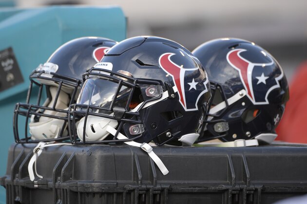 Houston Texans helmets sit behind the bench during the second half of an NFL football game against the Jacksonville Jaguars Sunday, Dec. 17, 2017, in Jacksonville, Fla. The Jaguars won 45-7. (AP Photo/Phelan M. Ebenhack)