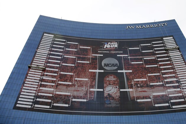 FILE- In this March 16, 2015, file photo, workers add team names to a 2015 NCAA Division I men's basketball tournament bracket that is displayed on the side of the JW Marriott in Indianapolis. With the Final Four a week away from shining a spotlight on Indianapolis, NCAA President Mark Emmert said Thursday, March 26, that the governing body for college sports is concerned about an Indiana law that could allow businesses to discriminate against gay people. (AP Photo/Darron Cummings, File)