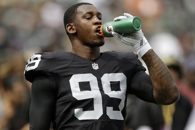 Oakland Raiders linebacker Aldon Smith (99) warms up before an NFL football game against the Cincinnati Bengals in Oakland, Calif., Sunday, Sept. 13, 2015. (AP Photo/Ben Margot)