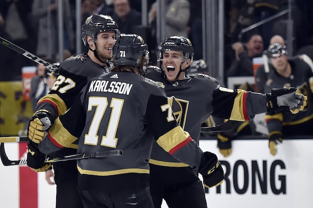 Vegas Golden Knights' Shea Theodore (27), William Karlsson (71) and Jonathan Marchessault celebrate Karlsson's goal against the Edmonton Oilers during the second period of an NHL hockey game Saturday, Jan. 13, 2018, in Las Vegas. (AP Photo/David Becker)