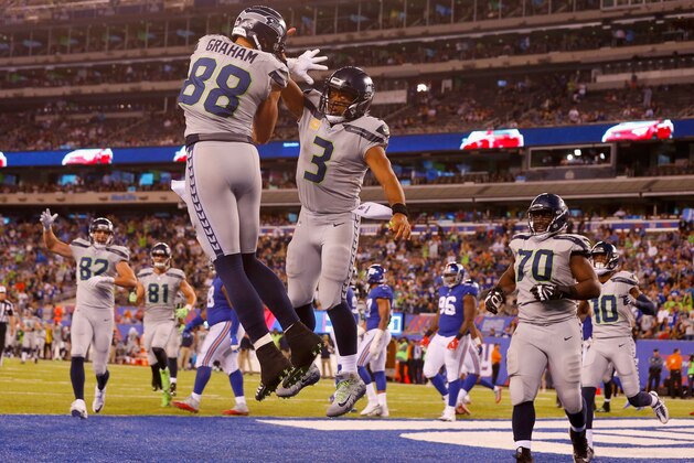 EAST RUTHERFORD, NJ - OCTOBER 22:  (NEW YORK DAILIES OUT)   Jimmy Graham #88 of the Seattle Seahawks celebrates a touchdown against the New York Giants with teammate Russell Wilson #3 on October 22, 2017 at MetLife Stadium in East Rutherford, New Jersey. The Seahawks defeated the Giants 24-7.  (Photo by Jim McIsaac/Getty Images)