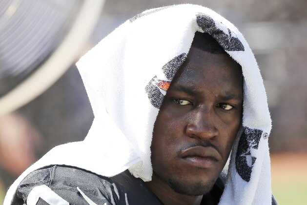 FILE - In this Sept. 20, 2015, file photo, Oakland Raiders defensive end Aldon Smith (99) cools off during an NFL football game against the Baltimore Ravens in Oakland , Calif. Every year, there are blue chippers carrying red flags. This season, the marketplace has Richie Incognito, Greg Hardy, Aldon Smith, Adam Jones, Andre Smith, Nick Fairley, Percy Harvin and Junior Galette. Lots of talent there, but plenty of locker room and off-field concerns, too. (AP Photo/Tony Avelar, File)